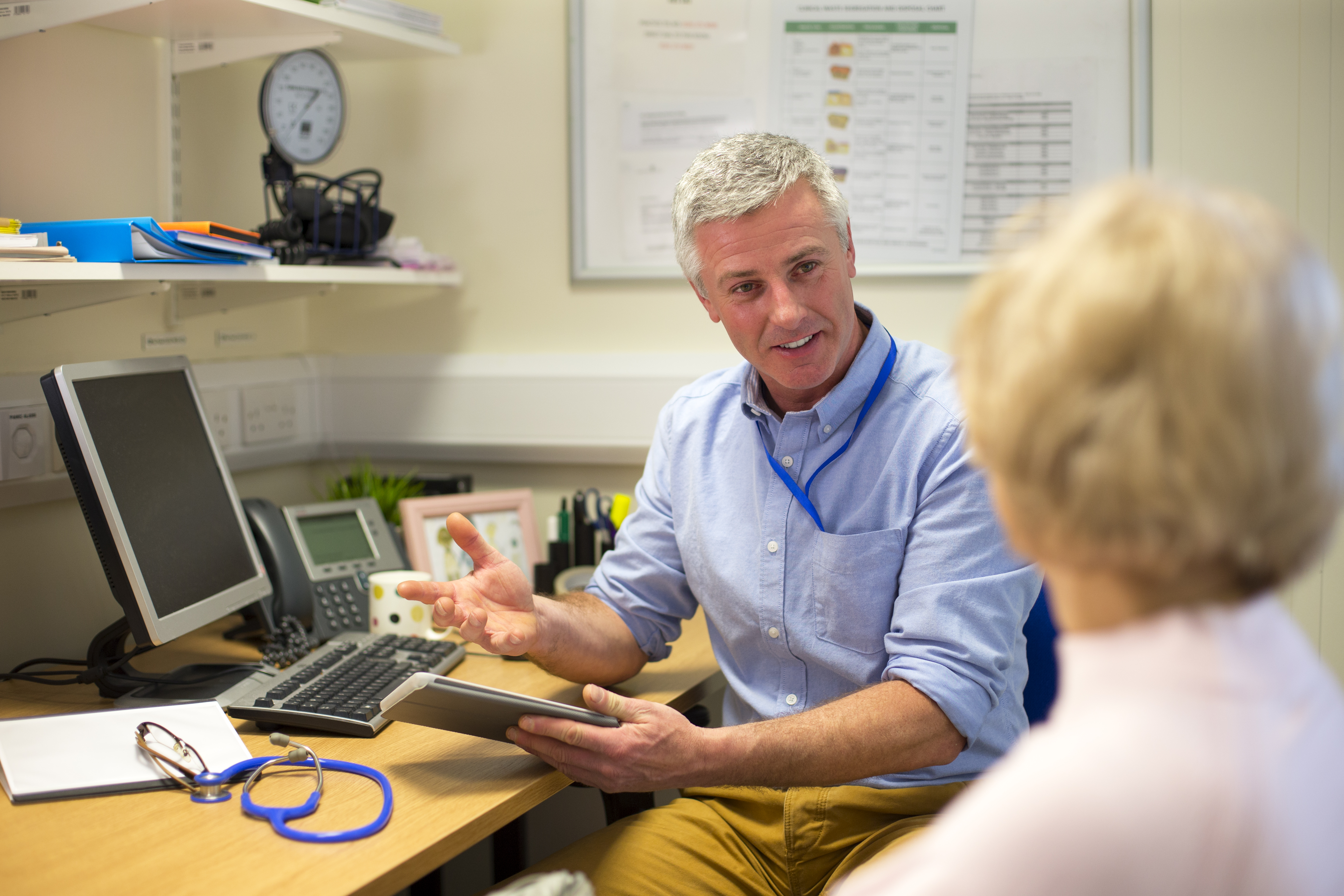 Patient sat in consultation room with GP