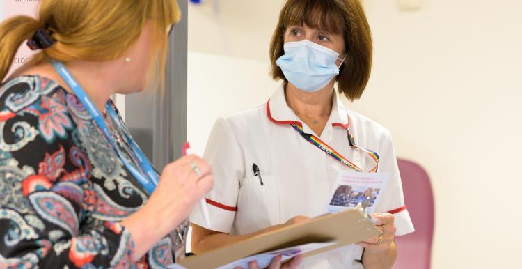 Female nurse talking to a Healthwatch employee