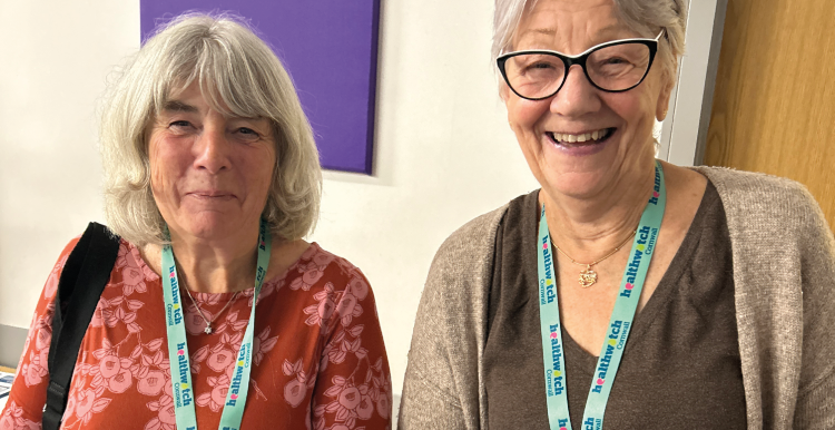 Photo of two Healthwatch Cornwall volunteers smiling to camera