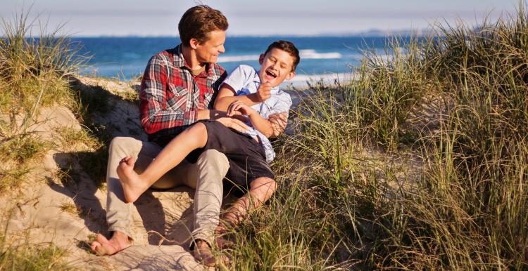 Photo of a dad and his son on a beach