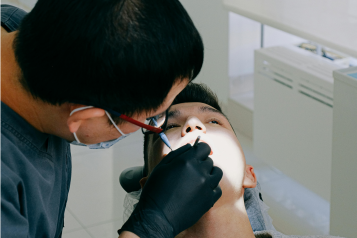 Male dentist working on male patient