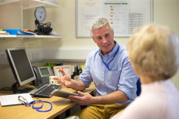 Patient sat in consultation room with GP