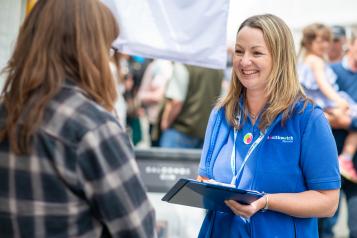 Woman smiling working at an event