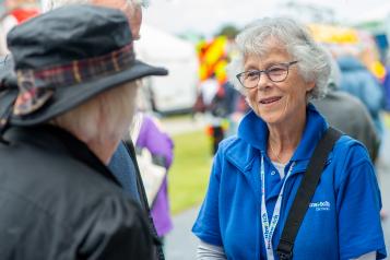 Woman from Healthwatch Cornwall speaking to a member of the public