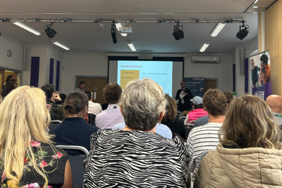 Group of attendees at the Mental Health Partnership Board Launch, shot from behind them