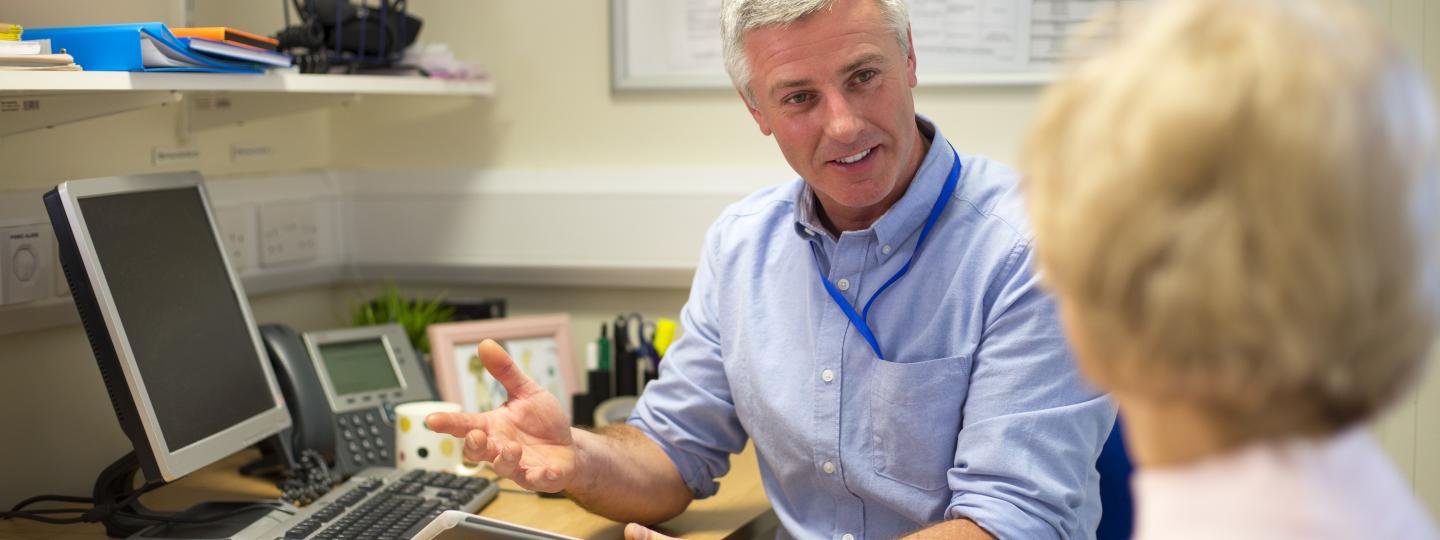 Image of a doctor and patient talking in a consultation room 