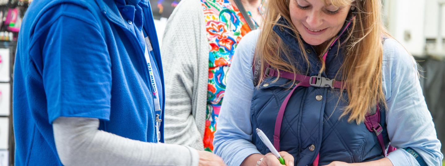 Healthwatch Cornwall volunteer talking to woman