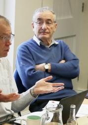 Three people having a discussion at a board meeting